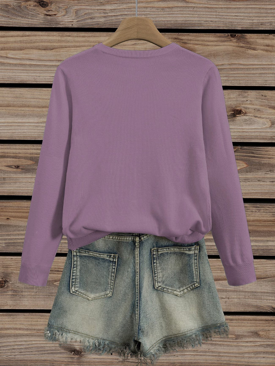 Pull col rond broderies florales — détail de la coupe et de l'encolure
